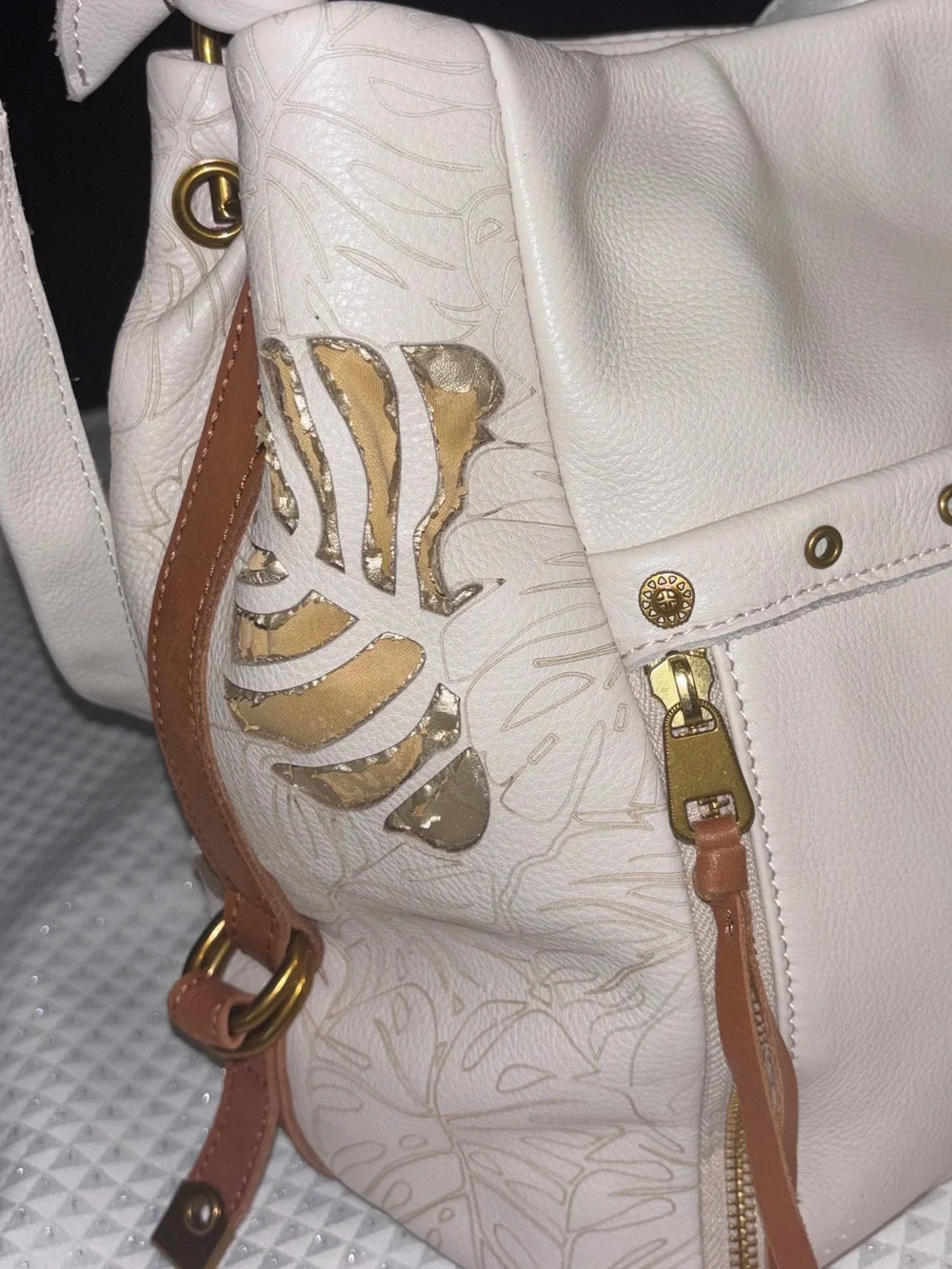 The Sak Cream Leather Shoulder Bag with Floral Cutout Accents
